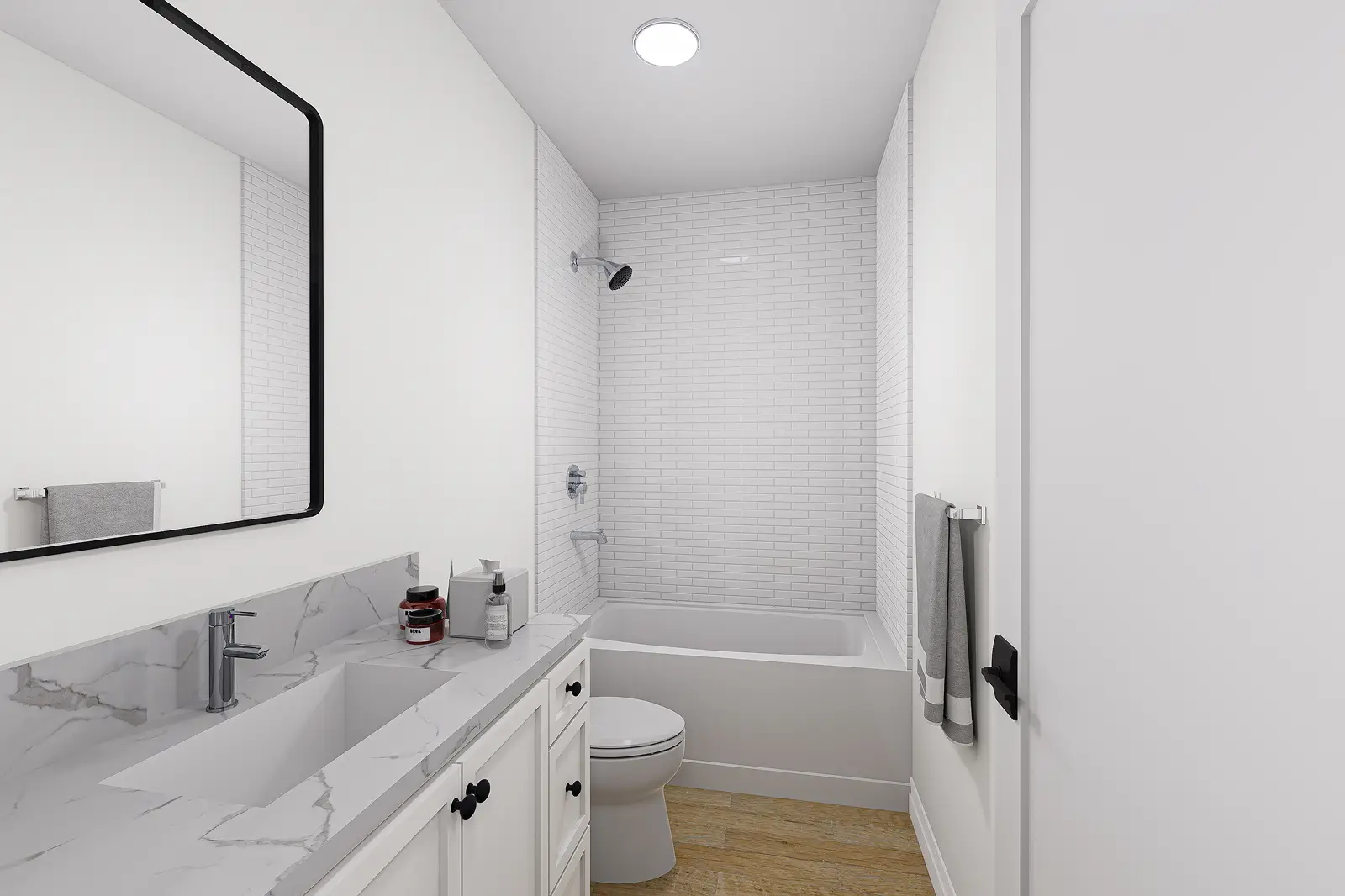 White bathroom with bathtub and marble sink.