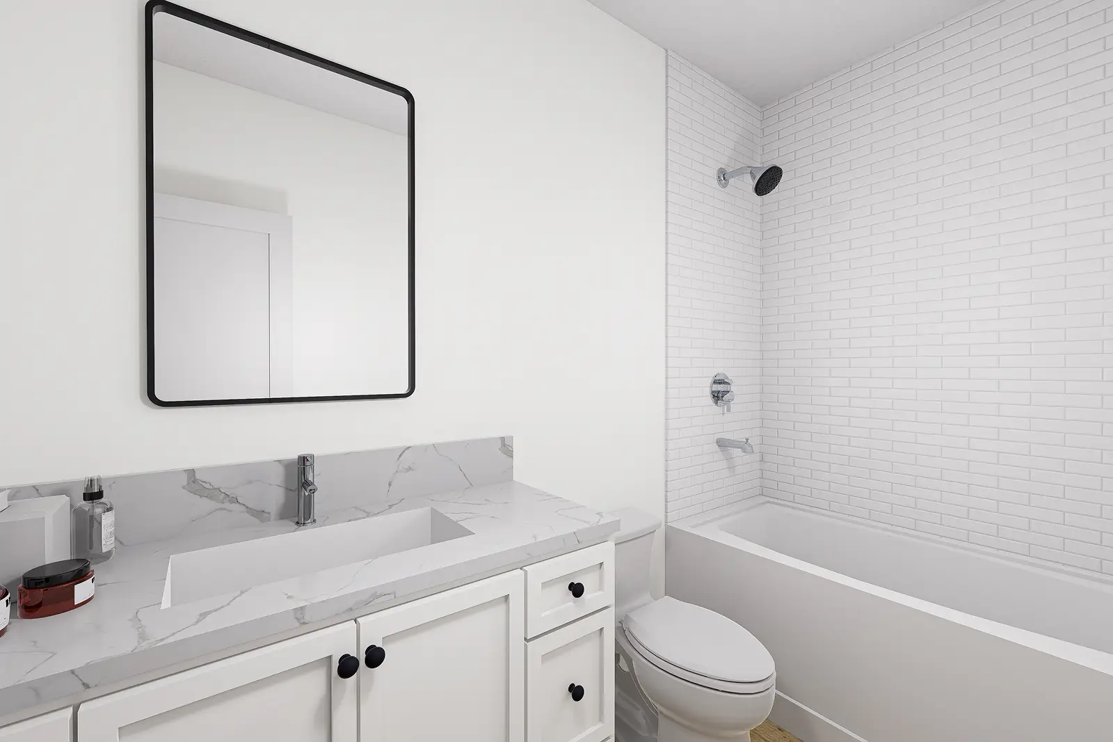 Modern white bathroom with marble countertop and tiled shower.