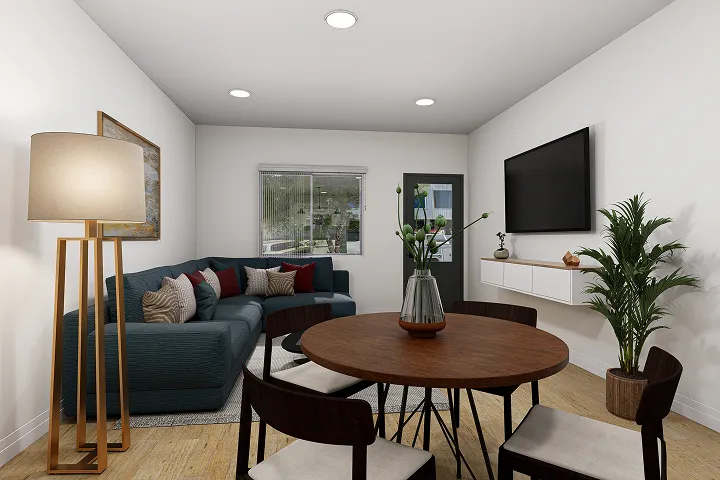 Modern living and dining room with dark wood furniture and green sofa.